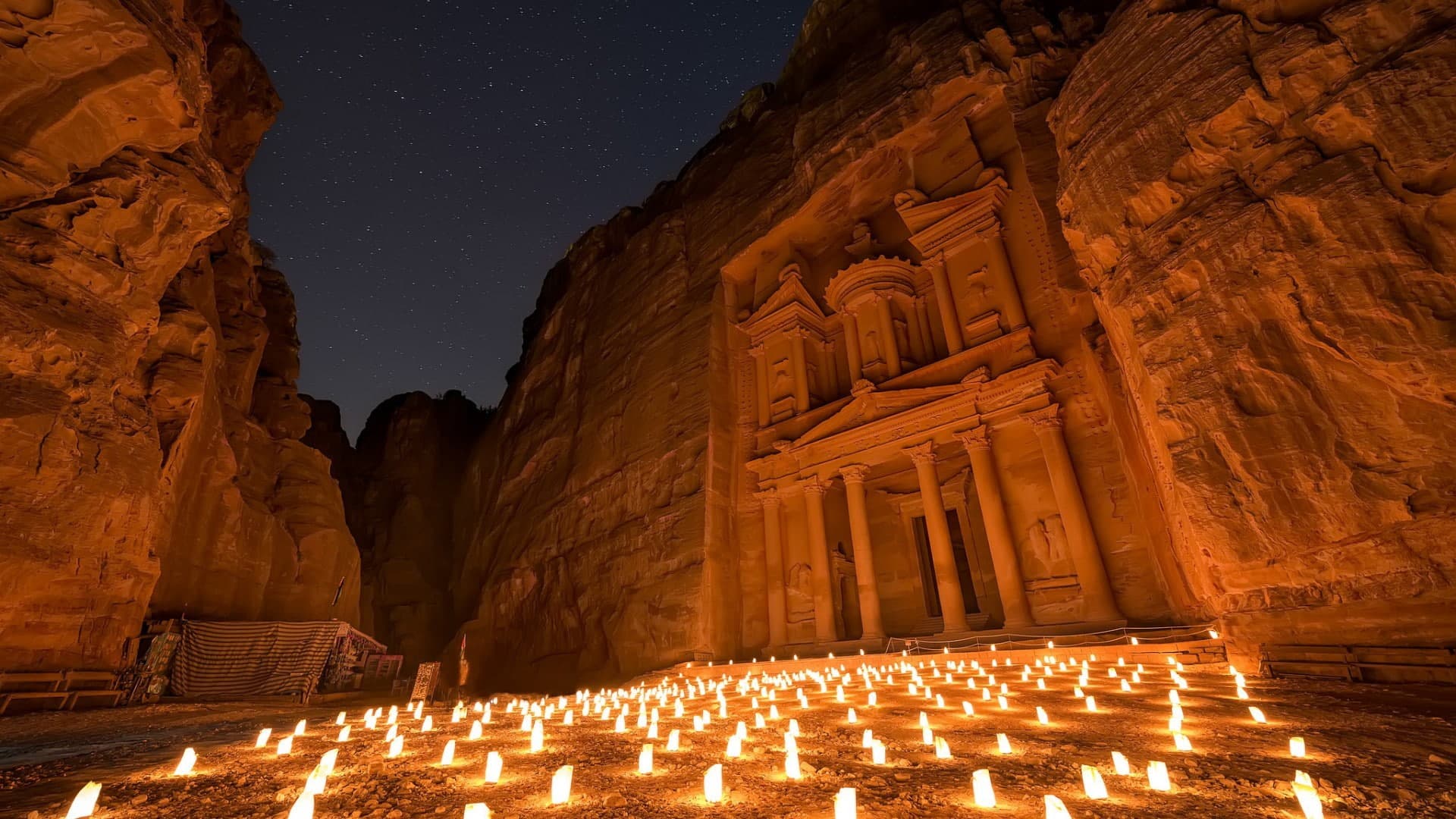 Petra by Night — the Treasury (Al-Khazneh) glowing over hundreds of candles under a starry sky